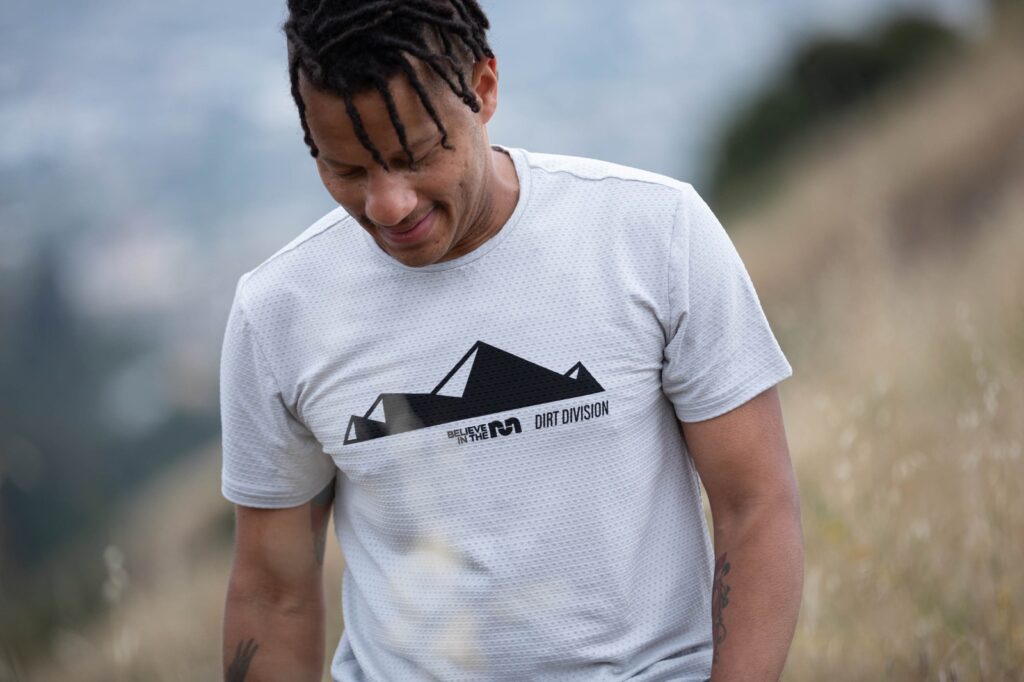 man wearing a believe in the run and path projects shirt