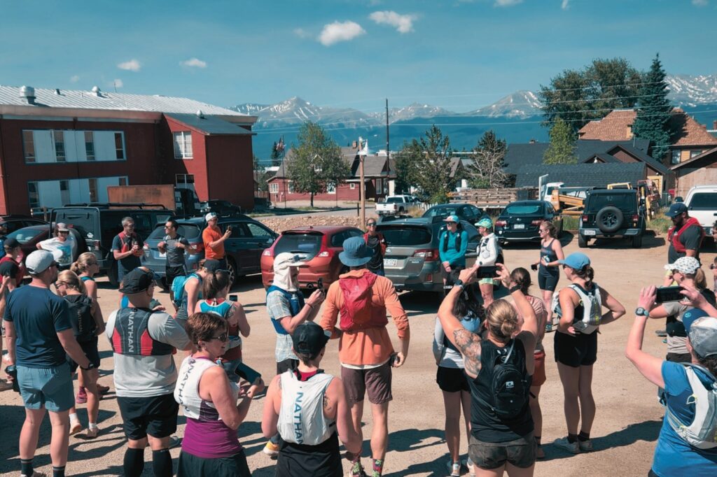A group of people standing in a parking lot.
