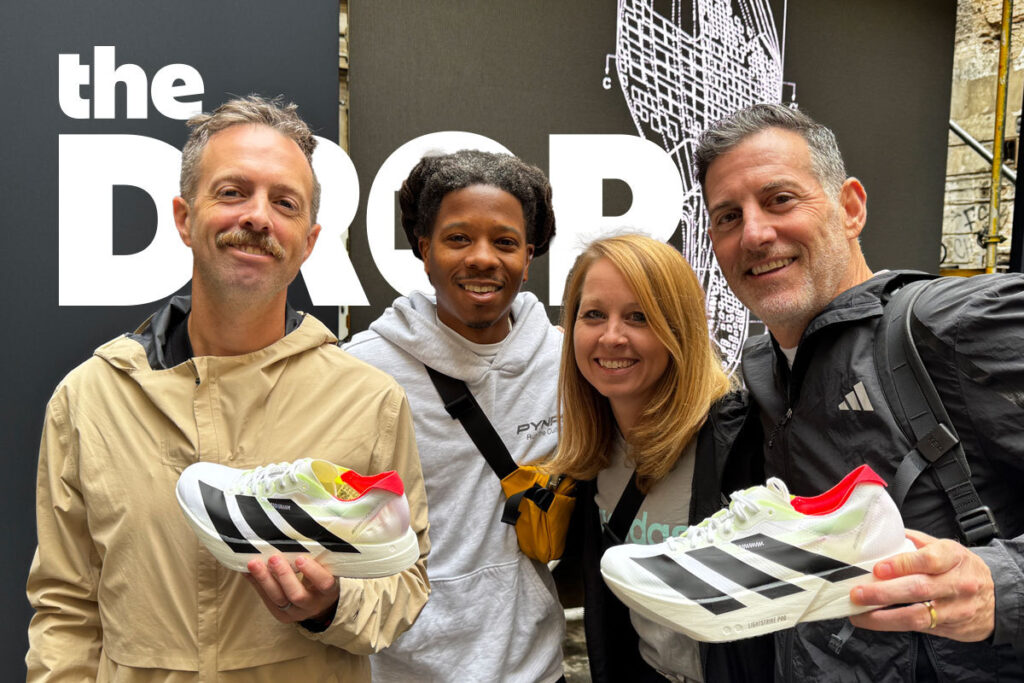 four people holding the adidas adios pro 4 running shoe