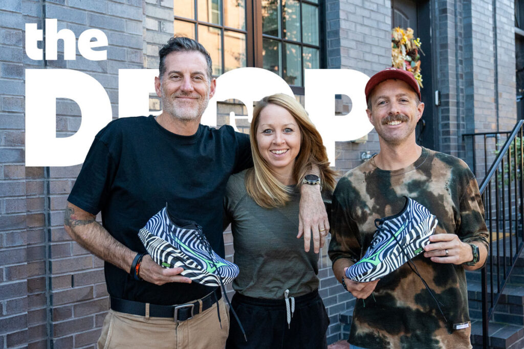 man holding zebra striped shoe on left and right, woman in the middle