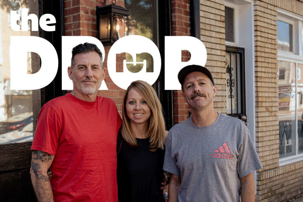 the drop podcasts hosts standing in front of a building