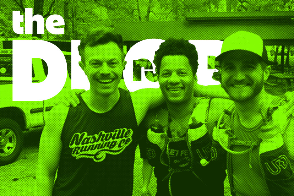three men smiling in a photo in running gear