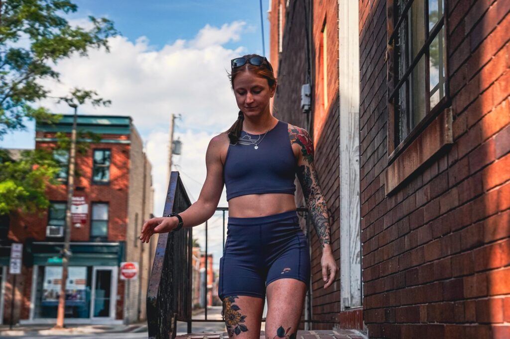 woman in running gear walking down staris