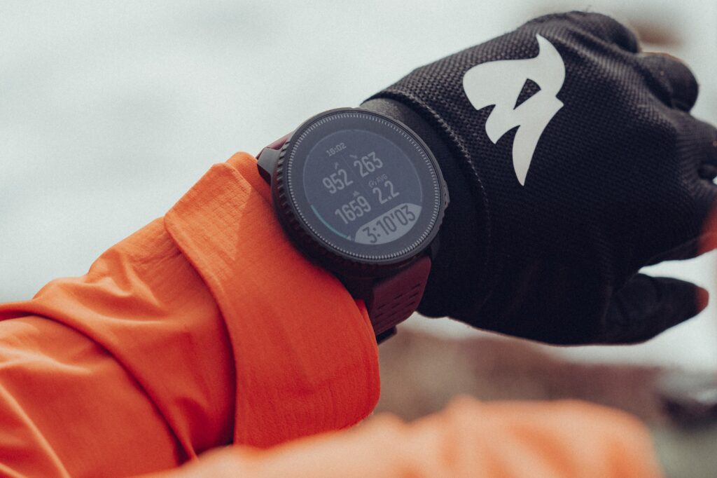 orange long sleeve shirt with watch and black glove